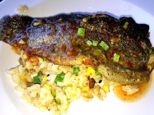 Cajun Spiced Trout - Blackened Ruby Red Trout with Pea and Corn Risotto with chili lime glaze for lunch. (at Gamlin Whiskey House)